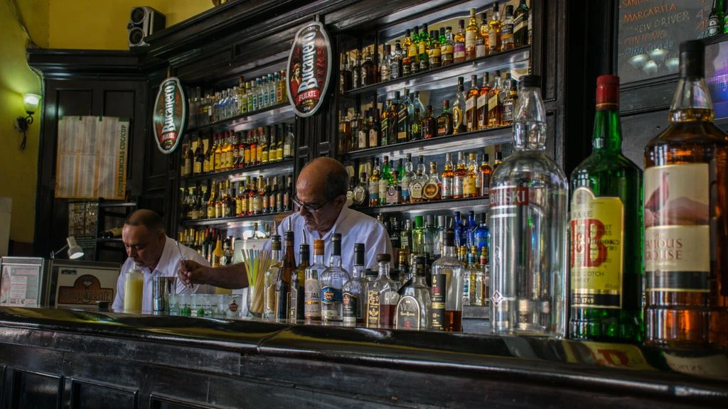 A bartender mid-shake at the Timba Social Club bar.